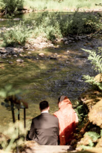 Newlyweds sharing a quiet moment by the water