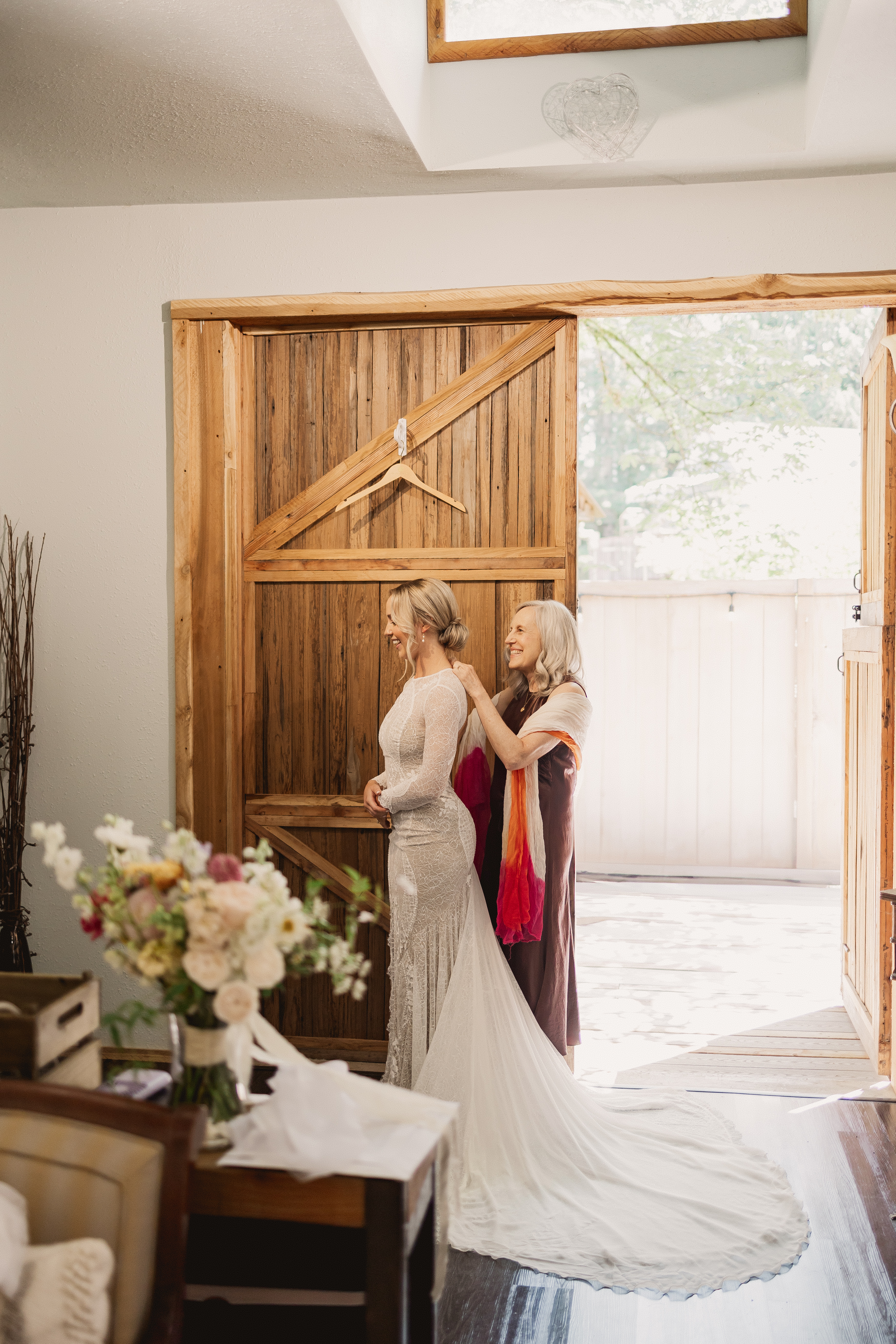 Bride putting on her dress in the Waterfront Barn Suite