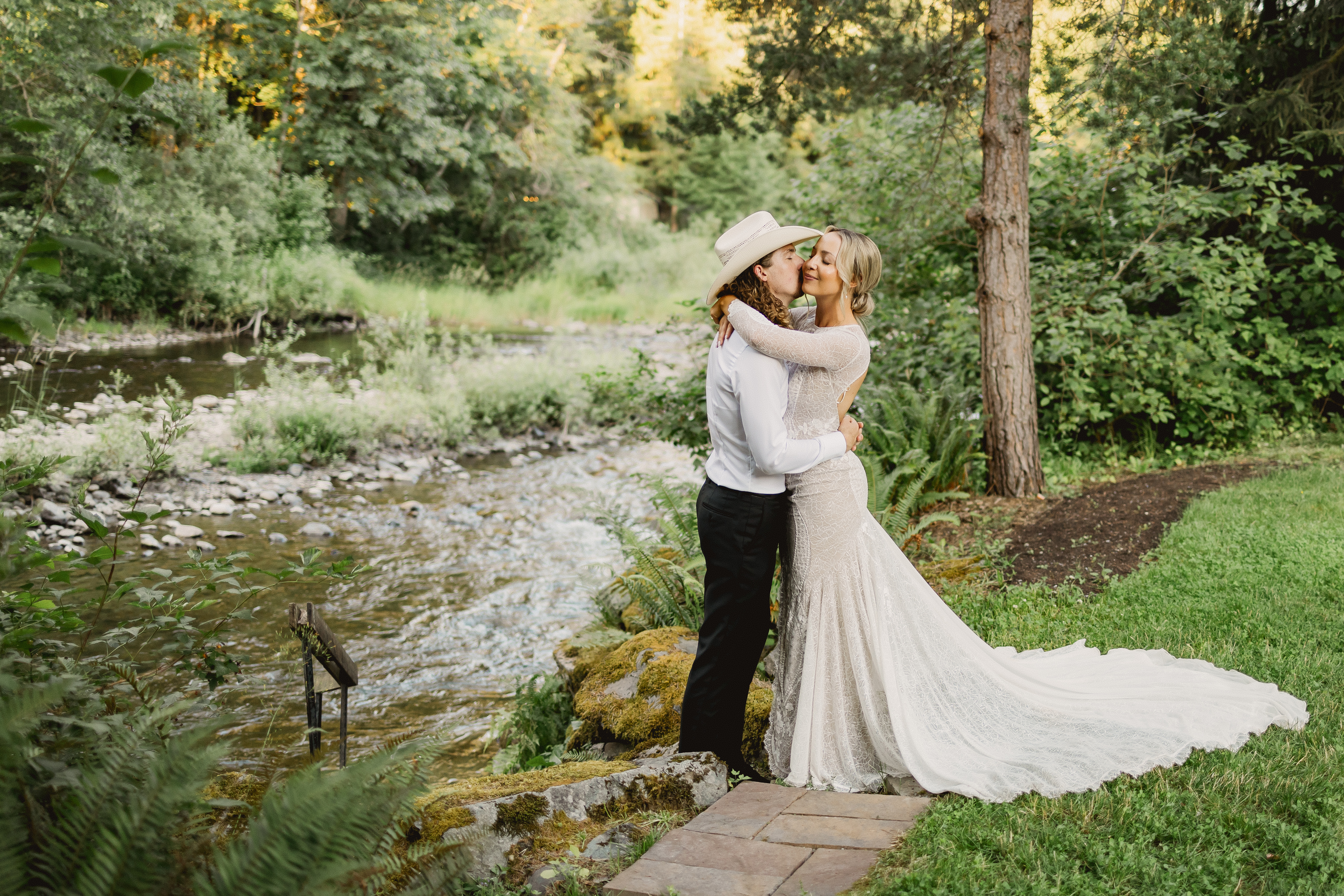 Couple silhouetted against the river at golden hour