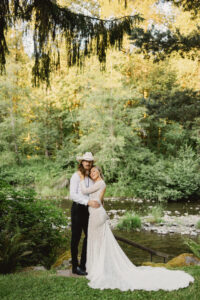 couple standing near river at waterfront wedding venue snohomish county