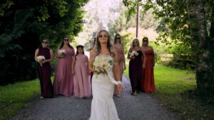 bride and bridesmaids walks down road