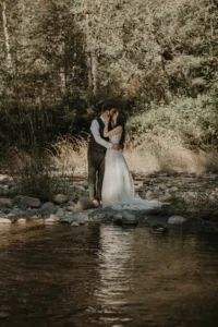 Newlyweds wading in the river for wedding portraits