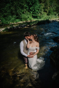 Couple standing in the river at River Valley Oasis