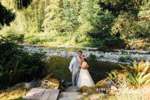 Riverside ceremony area surrounded by forest at River Valley Oasis