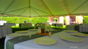 Venue staff arranging place settings at the reception tables