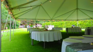 Waterfront tented dining area set up for a wedding at River Valley Oasis