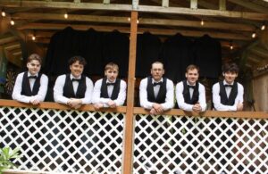 Groomsmen preparing in the River Cabin before the ceremony