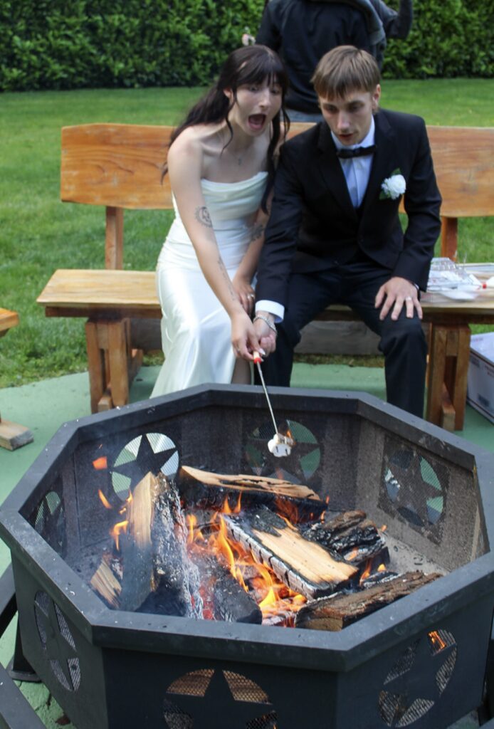couple making smores at the waterfront venue