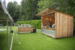 Custom wood bar with live-edge serving table at River Valley Oasis