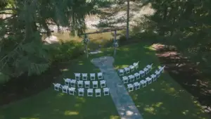 Ceremony arch framed by evergreens at River Valley Oasis