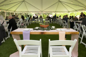 Bridal party head table with floral runner on wood tables