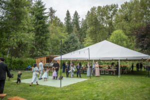 Reception tent set with wood tables at this Granite Falls wedding venue