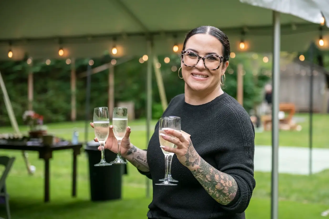 planning and venue manager helping serve champage toast at wedding