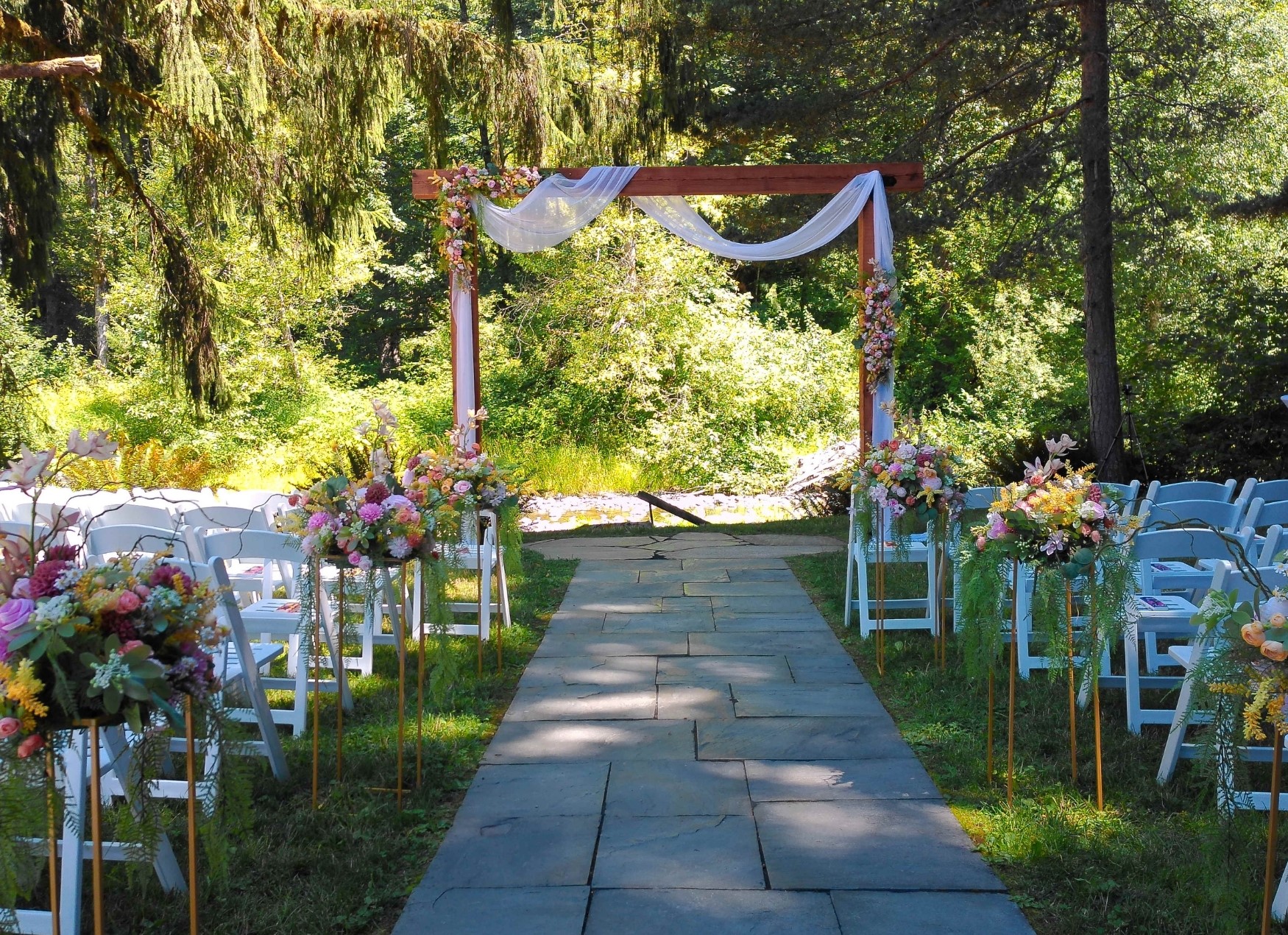 large ceremony arch decorated for a wedding at River Valley oasis wedding venue on pilchuck river